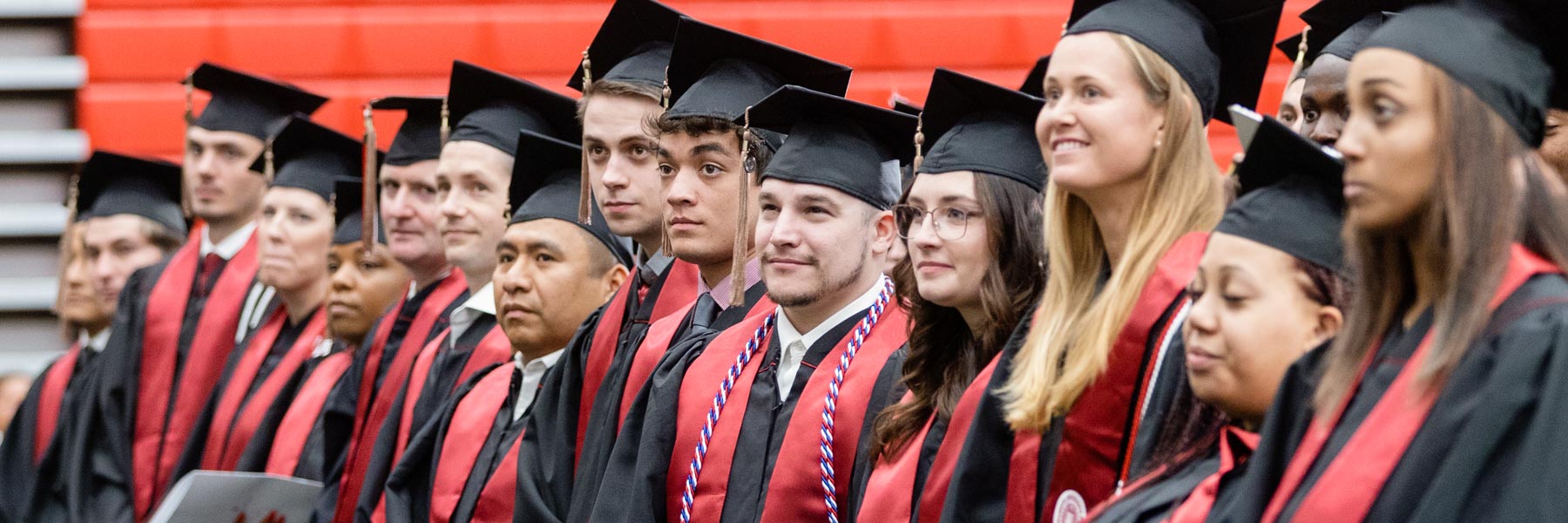 A line of proud IUE graduates of different ages and genders