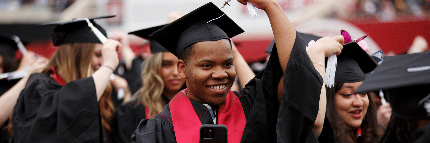 A male graduate turns his tassel at commencement.